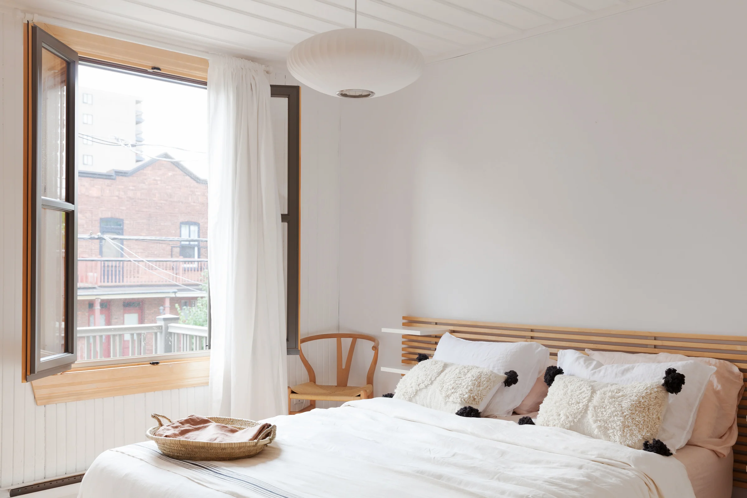A quiet bedroom at night with soft ambient light and a small glass of water on the bedside table
